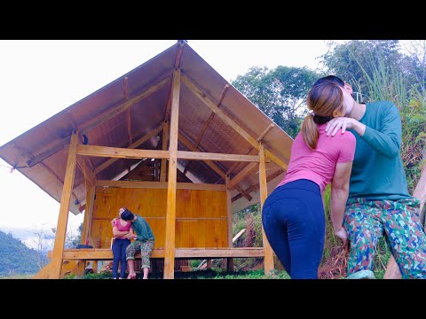 Happy girl kisses her boyfriend for helping make a beautiful house