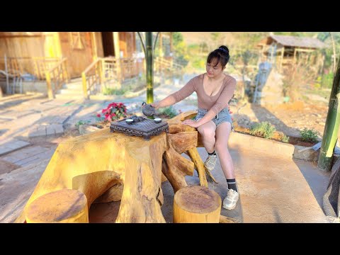 The girl took the tree stump and made it into a table and chairs set, placing it in the resort hut